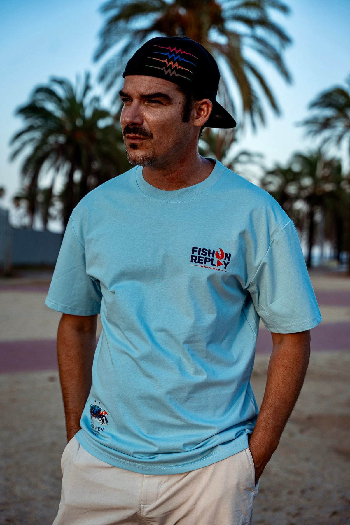 Modelo vistiendo la camiseta Crabbin' Crew Fish On Replay color azul cielo.